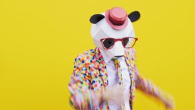 Funny character with mask dancing and having fun on a colored background