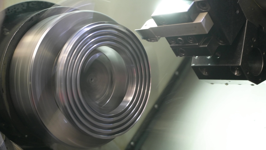 Turning operation on cnc machine in metalworking industry. Cutting tool makes spiral groove on metal detail face | Shutterstock HD Video #1073328959