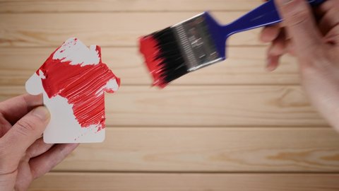 Painting work house renovation home construction. New house decoration paint brush renovation building. Symbol home painting brush in red color. Repair house remodeling renovation paint renew home