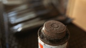 Old rusty and forgotten adhesive can with applicator covered in cobwebs on storage shelf of abandoned farm yard. - Powered by Shutterstock - Get 15% off with code: PIKWIZARD15