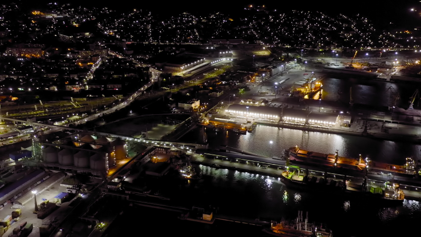 Novorossiysk, Russia. Port of Novorossiysk at night. Night city lights. Tsemesskaya Bay in the Black Sea, Aerial View