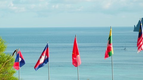 Blowing flags of ASEAN community - Laos, Cambodia
Malaysia, Vietnam, and union of Myanmar -Fluttering freely in sea background, mountains, and blue sky. And beautiful scenery of the island.