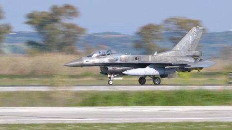 Andravida Greece APRIL, 03, 2019 NATO fighter jet slow down the speed on the runway after landing. Lockheed Martin F-16 C Fighting Falcon or Viper of Hellenic Air Force