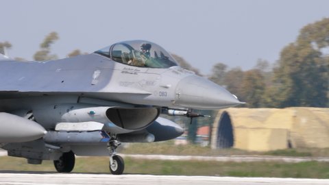 Andravida air Base Greece APRIL, 03, 2019 Close view of a military pilot greetings in the cockpit of an american Jet. Lockheed Martin F-16 C Fighting Falcon or Viper of United States Air Force USAF