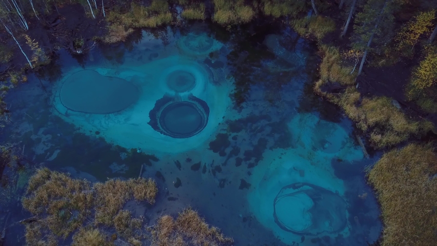 4K Aerial Footage Video of the Autumn Forest and Geyser Lake with Clear Blue Water near the village of Aktash in the Altai Mountains, Russia