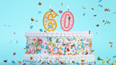 Birthday Cake With Burning Colorful Candles with Number 60 on Pastel Background. Falling confetti.
