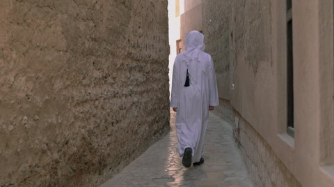 Portrait of arab man wearing dishdash kandura walking in the historical disctrict