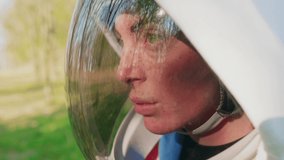 Emotionless spacewoman staring through helmet visor, side view - Powered by Shutterstock - Get 15% off with code: PIKWIZARD15