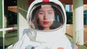 Close-up of Asian astronaut looking through helmet visor - Powered by Shutterstock - Get 15% off with code: PIKWIZARD15