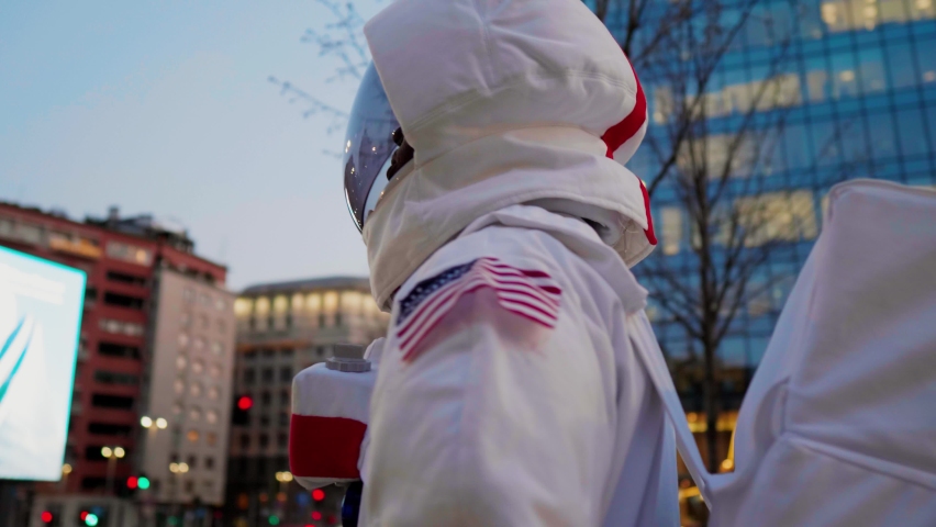 Spaceman standing in city, looking around