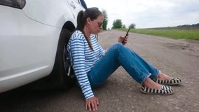 Woman waiting for helping near her car, soft focus background
