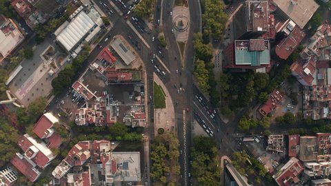 Aerial birds eye overhead top down view of heavy traffic in city streets. Multilane crossroads from drone flying forward. Mexico city, Mexico.