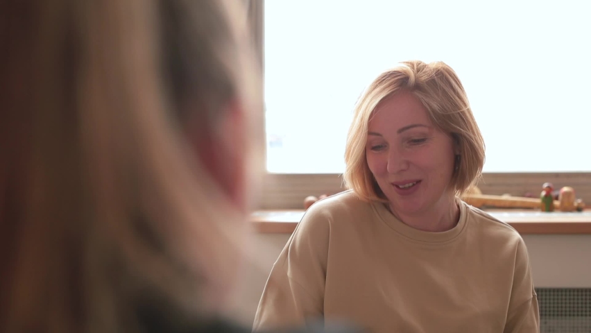 Woman talking. Camera movement. Focus attention topic conversation. Woman curator talks with patient, gestures. She explains. Joy on face in dialogue. Psychotherapy explores thoughts and feelings. Royalty-Free Stock Footage #1073368526