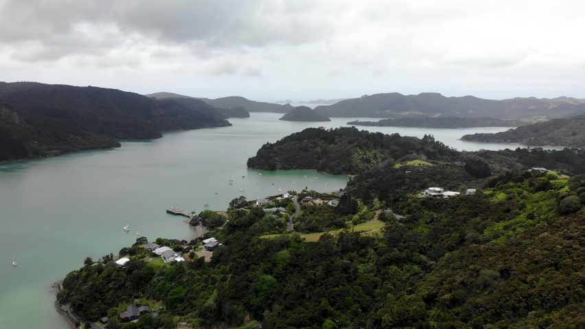 Aerial wide shot of tiny village and beautiful fiord in Whangaroa, New Zealand.