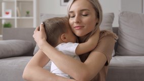 Happy young mum hugging kid son sooting sleepy kid at home. Cute toddler boy and caring mother bonding, cuddling together. Adorable small child boy and mom enjoying moments of love and affection. - Powered by Shutterstock - Get 15% off with code: PIKWIZARD15