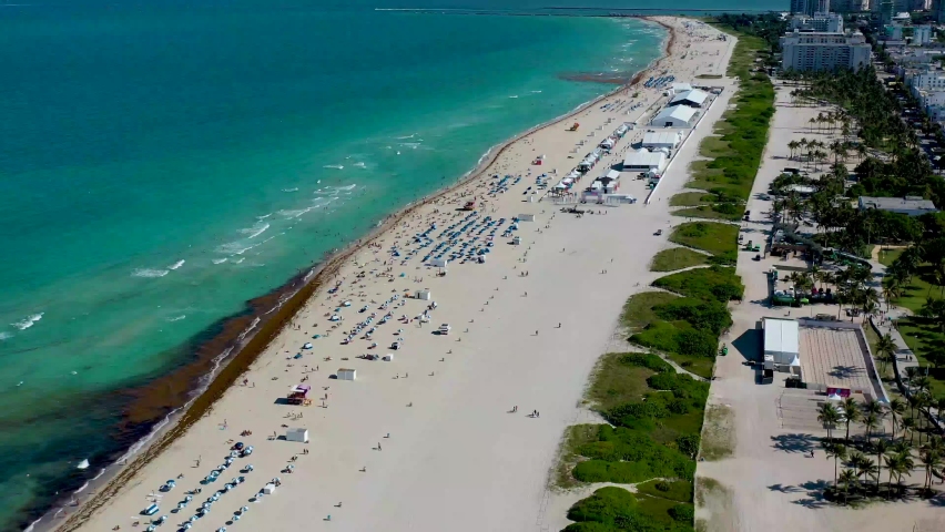 Drone footage 4K of Miami South Beach. Aerial view of Miami Beach in Florida, USA. Flying above white beach and ocean view from above. | Shutterstock HD Video #1073385461