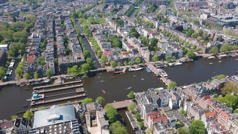 Amsterdam, 30th of May 2021, The Netherlands. Amstel river Amsterdam city center hyperlapse on a sunny day with boats on the canals.
