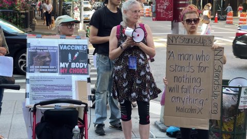 NYC, USA - MAY 29, 2021: anti-vaxxers with signs and bullhorns in New York City.