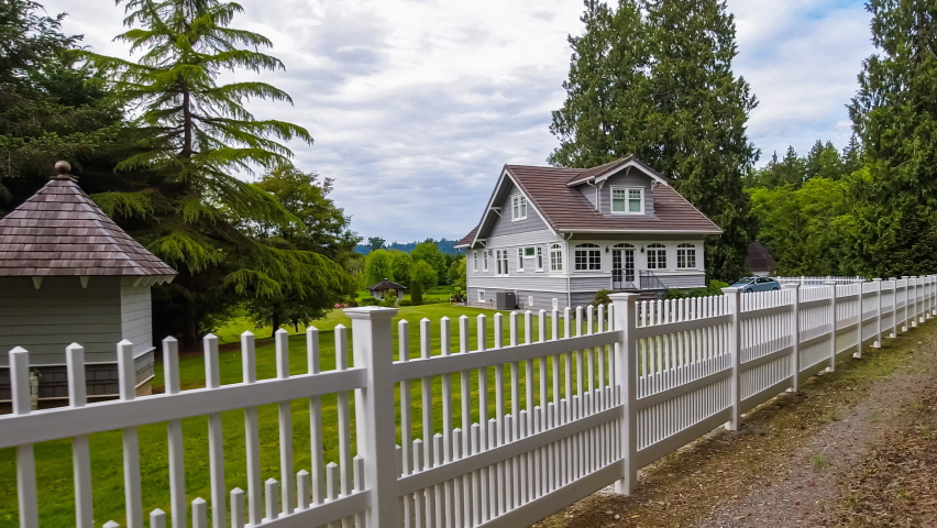 Passing by a quaint rural cottage style home with white picket fence