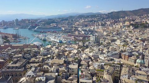 GENOA,ITALY - SEPTEMBER,2020.Aerial panoramic drone view of buildings and streets surrounding Port.Cruise ships and ferries port.Old famous city with roofs of old buildings,historical streets.4K video