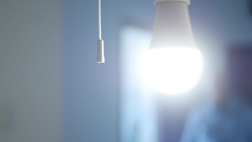 One Person Pull the Switch Cord and Turns Off the Light in a Room. Shutting Down the Led Light in the Office and Leaving the Room. Royalty-Free Stock Footage #1073419619