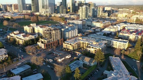 Cinematic aerial sunset drone rise and reveal footage of Clyde, downtown, commercial area of Bellevue near Seattle, Washington