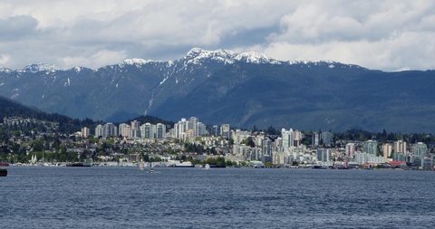 North Vancouver cityscape mountains and Vancouver inlet.