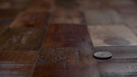 Coin Bounces On The Wooden Floor. close up
