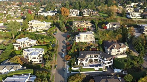 Cinematic aerial drone footage of the hillside in Central Houghton, Kirkland, Lake Washington, affluent residential neighborhood near Bellevue in autumn foliage