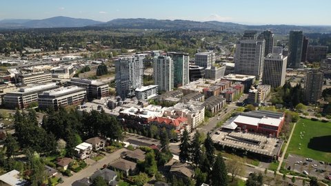 Cinematic aerial orbiting drone footage of the city center, commercial district of Bellevue near Downtown Park and Bellevue Square, skyscrapers, office and apartment buildings near Seattle, Washington