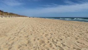 Beautiful sunny day on a calm pristine beach with blue skies in North Carolina in the Outer Banks in Nags Head during early summer