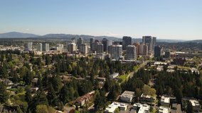Cinematic 4K aerial drone video of the city center, commercial district of Bellevue near Downtown Park and Bellevue Square, skyscrapers, office and apartment buildings near Seattle, Washington