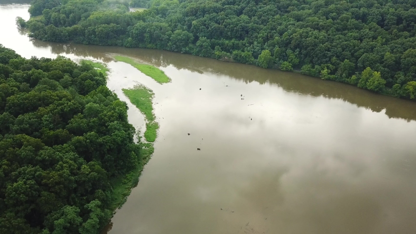 Forward shot over the water and the trees in the mountains