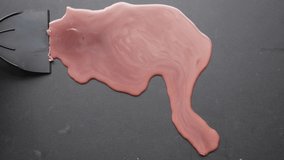 Red wax being satisfyingly scraped off a black surface. - Powered by Shutterstock - Get 15% off with code: PIKWIZARD15