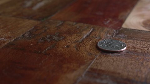 Quarter Dollar Coin Spins On The Wooden Floor. close up