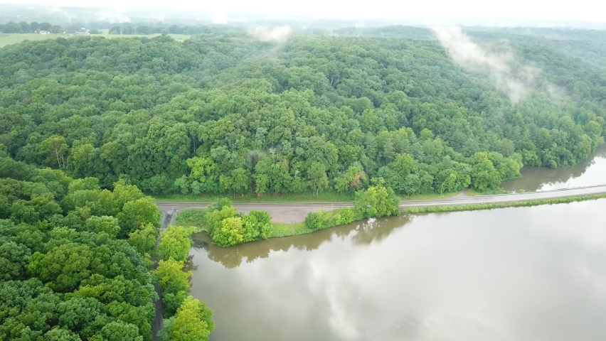 Reverse shot over the trees and swamp in the mountains