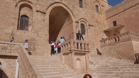 Midyat, Mardin, Turkey - January 2020: Tourists visiting Mor Gabriel Deyrulumur Monastry is the oldest surviving Syriac Orthodox monastery in the world.