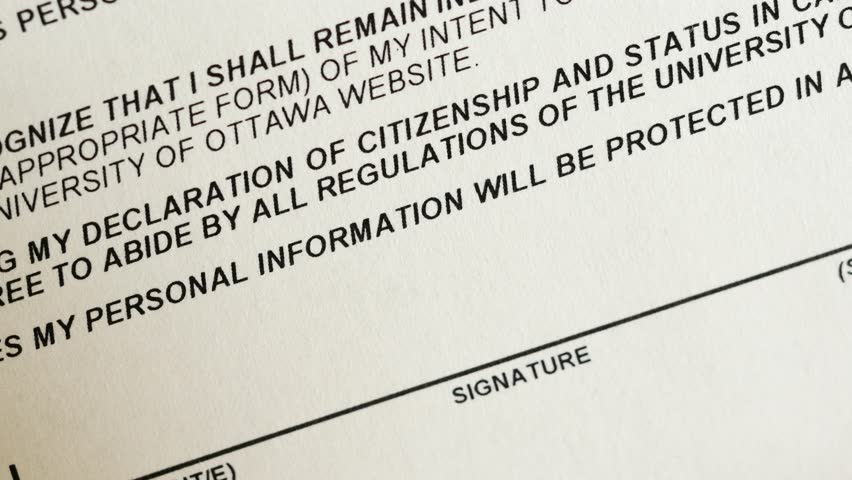 Signing official document with a blue ink pen. Closeup shot of the signature.