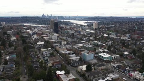 Cinematic aerial drone dolly shot of University District, Bryant, Northlake, North Broadway, Laurelhurst, I-5 freeway with Lake Union, Union Bay, Lake Washington and downtown Seattle in the distance