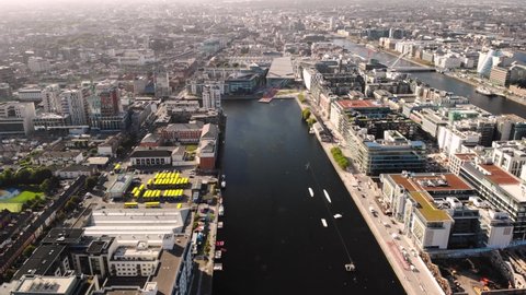 Aerial birds eye view of Grand Canal Dock. Reveal of Dublin city centre. Sunny day in Ireland.