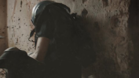CU Portrait of Caucasian female war journalist wearing protective helmet and bulletproof vest gear taking photos under fire. Shot with 2x anamorphic lens