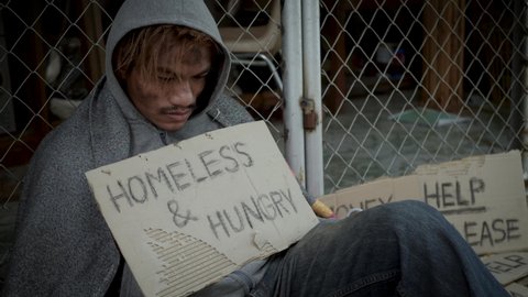 Homeless man with dirty clothes getting bread from kind people and eating with gluttonous, hunger. 4K