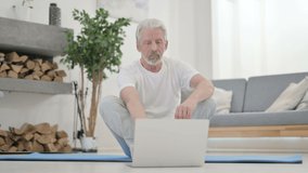 Senior Old Man Talking on Video Call on Yoga Mat at Home