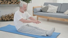 Senior Old Man doing Yoga on Yoga Mat at Home