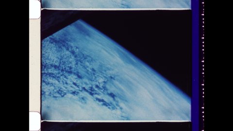 1969. View of Deep Space from Spacecraft Window onboard Apollo 11. The Earth's Ocean pass by the Window and onto the Sun's Illuminating Abstraction. 4K Overscan of Vintage Archival 16mm Film Print