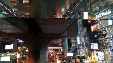 BANGKOK, THAILAND, 13 JULY 2019 Rush hour urban vehicles traffic near MBK, Siam Discovery and Paragon Square reflected upside down in mirror. Downtown modern city life colorful perspective reflection
