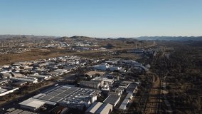 4K bright summer morning aerial video of Namibia Brewery beer factory and its hangars located in Windhoek Northern Industrial area, Khomas Region, central Namibia, southern Africa