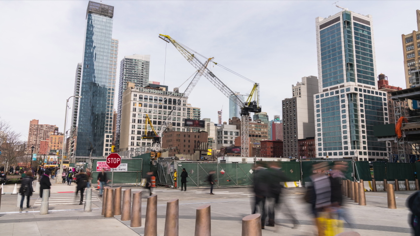 Time-lapse of crane under construction site, American people walking on pedestrian walkway in New York City, USA. Construction industry or transportation concept Royalty-Free Stock Footage #1073459078