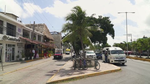 TULUM, MEXICO - CIRCA 2021: Car traffic in central Tulum, a small touristic place in Riviera Maya in Quintana Roo state of Mexico