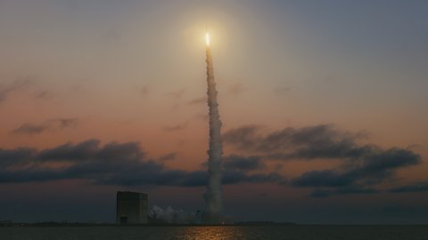 Rocket Launch to space into the sjy at sunset or dusk with clouds and beautiful sky. Slow motion. 4K
